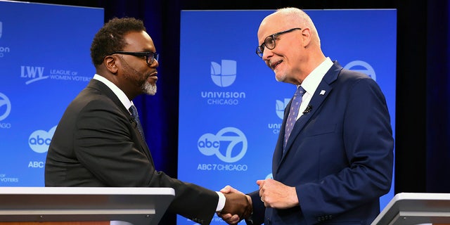 Chicago mayoral candidates Brandon Johnson, left, and Paul Vallas shake hands before the start of a debate at ABC7 studios in downtown Chicago on March 16, 2023.