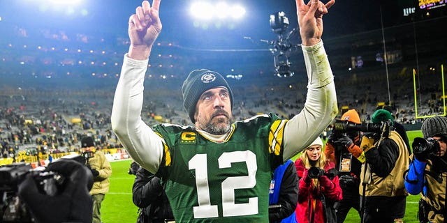 Quarterback Aaron Rodgers waves after the Packers defeated the Los Angeles Rams at Lambeau Field on Dec. 19, 2022, in Green Bay, Wisconsin.