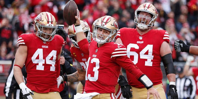 San Francisco 49ers quarterback Brock Purdy (13) celebrates with teammates after running for a touchdown against the Tampa Bay Buccaneers during the first half of an NFL football game in Santa Clara, Calif., Sunday, Dec. 11, 2022. 