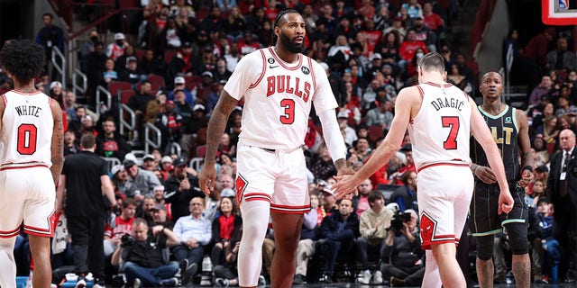 Andre Drummond (3) of the Chicago Bulls high-fives Goran Dragic (7) during a game against the Indiana Pacers Feb. 2, 2023, at United Center in Chicago. 