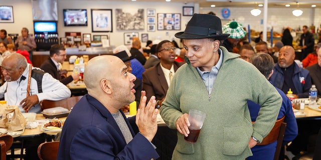 Chicago Mayor Lori Lightfoot chats with a supporter after eating lunch at Manny's Cafeteria and Delicatessen on Feb. 28, 2023.