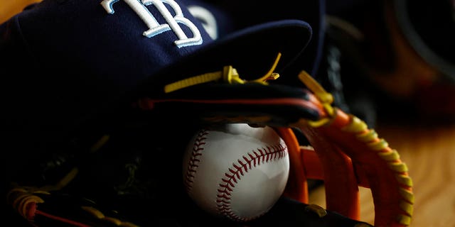 Detailed view of a Tampa Bay Rays hat, glove and MLB baseball during the first inning of the game against the Baltimore Orioles at Tropicana Field on Aug. 13, 2022 in St Petersburg, Florida. 