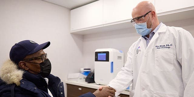 A doctor in Mount Sinai Hospital Service's new mobile cancer unit shakes the hand of a patient