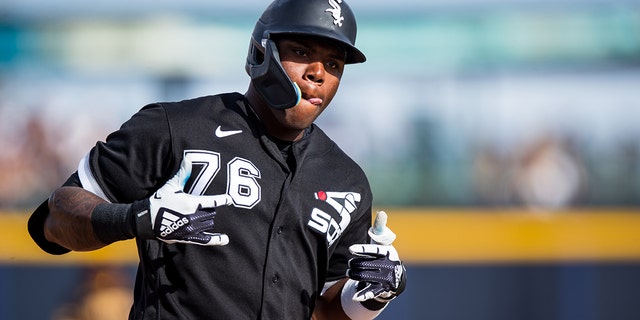 Oscar Colas #76 of the Chicago White Sox gestures while rounding the bases after hitting a home run during the eighth inning of the Spring Training Game against the San Diego Padres at Peoria Stadium on March 11, 2023 in Peoria, Arizona.