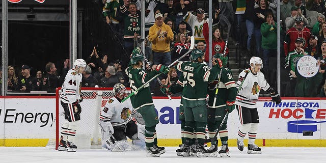Minnesota Wild right wing Ryan Reaves, #75, celebrates with teammates after scoring a goal against the Chicago Blackhawks during the second period of an NHL hockey game Saturday, March 25, 2023, in St. Paul, Minnesota.