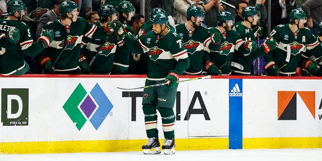 Ryan Reaves, #75 of the Minnesota Wild, skates by the Wild bench and celebrates his goal with teammates in the second period of the game against the Chicago Blackhawks at Xcel Energy Center on March 25, 2023 in St Paul, Minnesota.