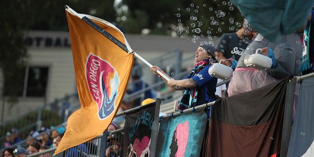 A fan holds a Wave FC flag prior to the match against Orlando Pride at Torero Stadium on Aug. 13, 2022 in San Diego, California.