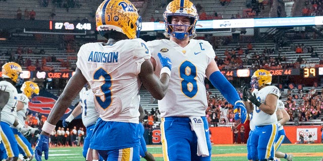 Pittsburgh Panthers quarterback Kenny Pickett (8) congratulates receiver Jordan Addison (3) for scoring a touchdown in a game against the Syracuse Orange Nov. 27, 2021, at the Carrier Dome in Syracuse, N.Y. 