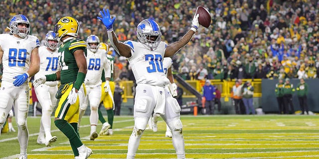 Jamaal Williams #30 of the Detroit Lions celebrates a touchdown during a game against the Green Bay Packers at Lambeau Field on January 08, 2023 in Green Bay, Wisconsin. The Lions defeated the Packers 20-16.