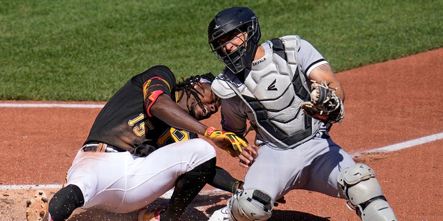 Pittsburgh Pirates' Oneil Cruz (15) is injured as he is tagged out attempting to score by Chicago White Sox catcher Seby Zavala during the sixth inning of a baseball game in Pittsburgh, Sunday, April 9, 2023. A bench clearing brawl ensued as a result of the play.