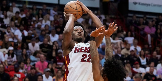 Miami Heat forward Jimmy Butler, #22, shoots over Chicago Bulls guard Coby White, #0, during the first half of an NBA basketball play-in tournament game, Friday, April 14, 2023, in Miami.