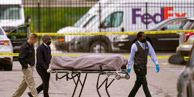 A body is taken from the scene of a shooting at a FedEx Ground facility in Indianapolis, Indiana, on April 16, 2021. The son of one of the men killed in the shooting filed a lawsuit on April 13, 2023, with two survivors against the distributor of the magazine used by the gunman.