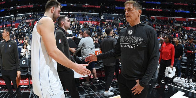 Luka Doncic of the Dallas Mavericks and team owner Mark Cuban shake hands during the game against the Los Angeles Clippers at Crypto.Com Arena in Los Angeles on Jan. 10, 2023.