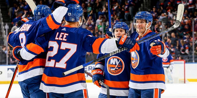 Anders Lee of the Islanders is congratulated by his teammates after scoring a goal against the Montreal Canadiens at UBS Arena on April 12, 2023, in Elmont, New York.