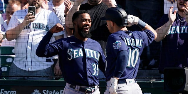 Jarred Kelenic of the Seattle Mariners is congratulated by Teoscar Hernandez following a home run against the Cubs at Wrigley Field on April 12, 2023, in Chicago.