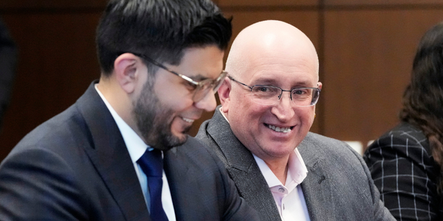  Robert E. Crimo Jr., right, father of Robert Crimo III, smiles as he sits with his attorney George Gomez, left, during an appearance before Judge George D. Strickland at the Lake County, Ill., Courthouse, Tuesday, April 4, 2023, in Waukegan, Ill. 
