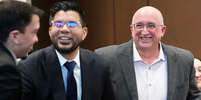 Robert E. Crimo Jr., right, father of Robert Crimo III, smiles as he sits with his attorney George Gomez, left, during an appearance before Judge George D. Strickland at the Lake County, Ill., Courthouse, Tuesday, April 4, 2023, in Waukegan, Ill. 