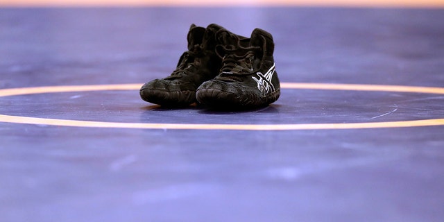 Shoes sit on wrestling mat