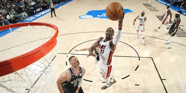 Bam Adebayo #13 of the Miami Heat drives to the basket during the game against the Milwaukee Bucks during Round One Game One of the 2023 NBA Playoffs on April 16, 2023 at the Fiserv Forum Center in Milwaukee, Wisconsin.