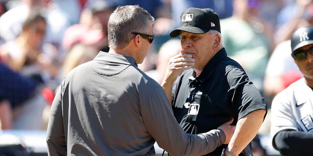 Umpire Larry Vanover is checked out by a trainer after getting hit by a thrown ball from Andres Gimenez of the Cleveland Guardians during the fifth inning against the New York Yankees at Progressive Field April 12, 2023, in Cleveland.