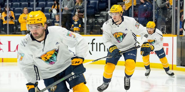 Cal Foote #52 and Kiefer Sherwood #44 of the Nashville Predators take the ice for warmups on Hockey Is For Everyone night prior to an NHL game against the Vegas Golden Knights at Bridgestone Arena on April 4, 2023 in Nashville, Tennessee. 