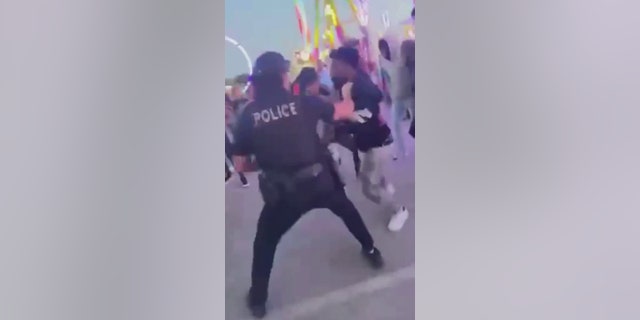 police officer breaking up teen fight