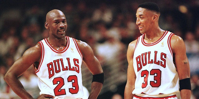 Michael Jordan and Scottie Pippen talk during a Bulls game