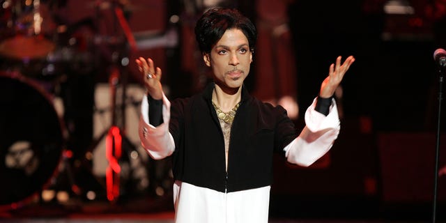 Prince on stage with arms out