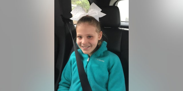 Mallory Grossman wearing a cheerleading bow in her hair