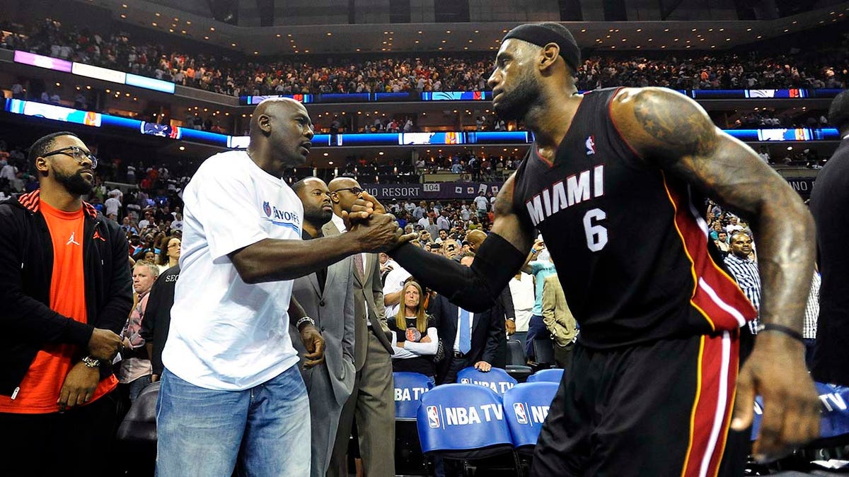Michael Jordan shakes hands with LeBron James