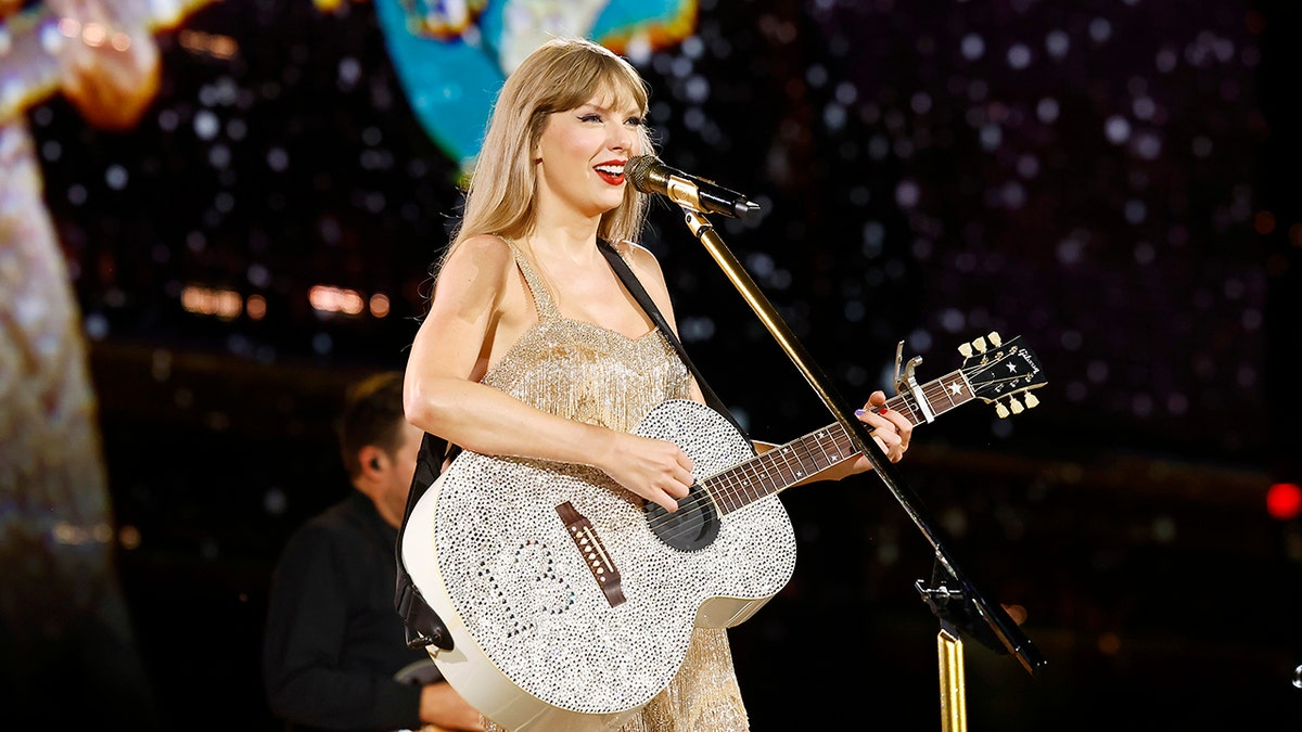 Taylor Swift onstage with guitar