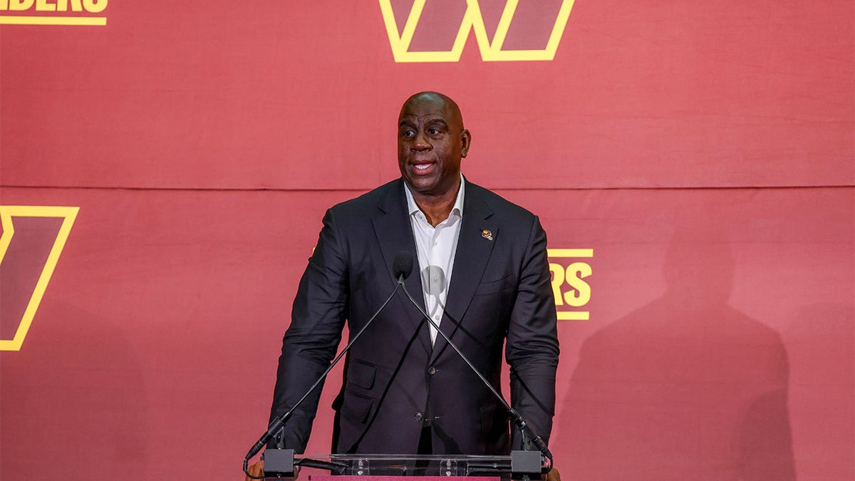 Magic Johnson talks during a press conference