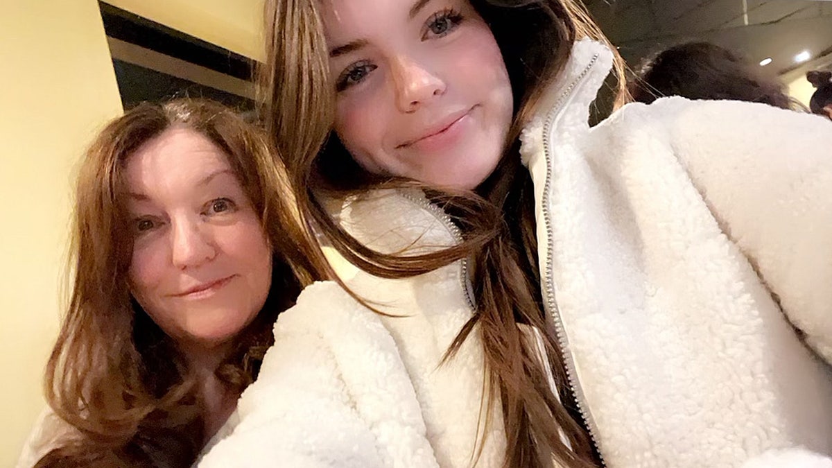 Mother and daughter pose for a selfie.