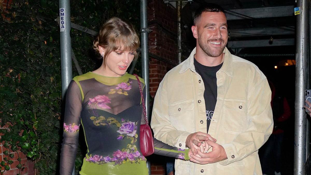 Taylor Swift sports black leather mini skirt and sheer top with Travis Kelce