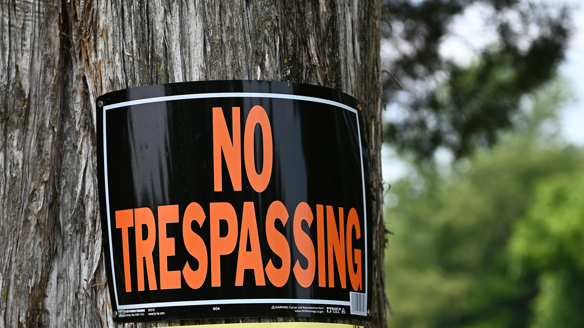 No trespassing sign on a tree