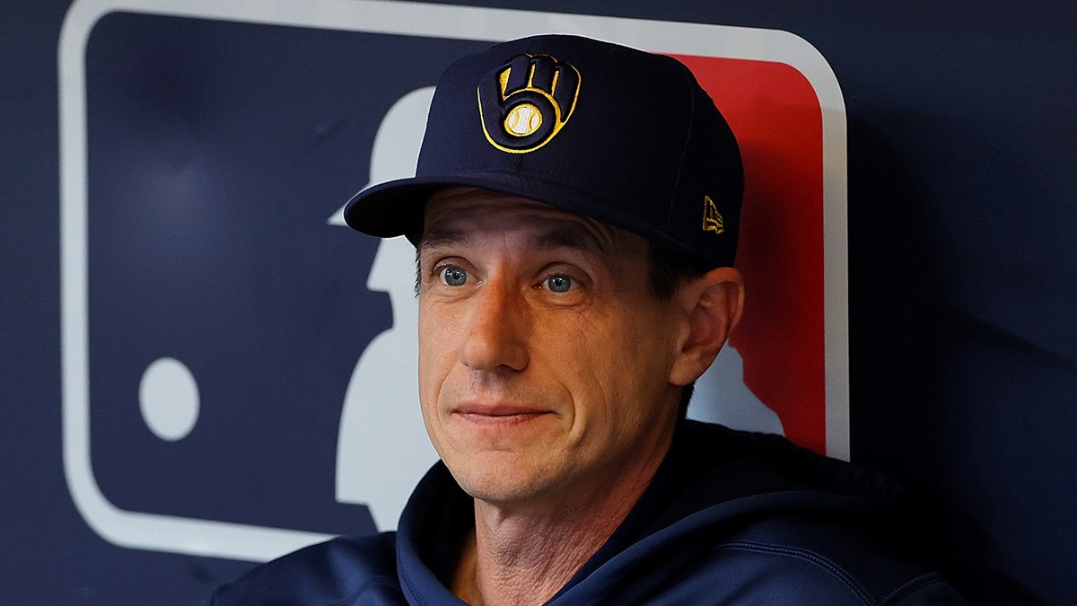 Craig Counsell looks on field from dugout