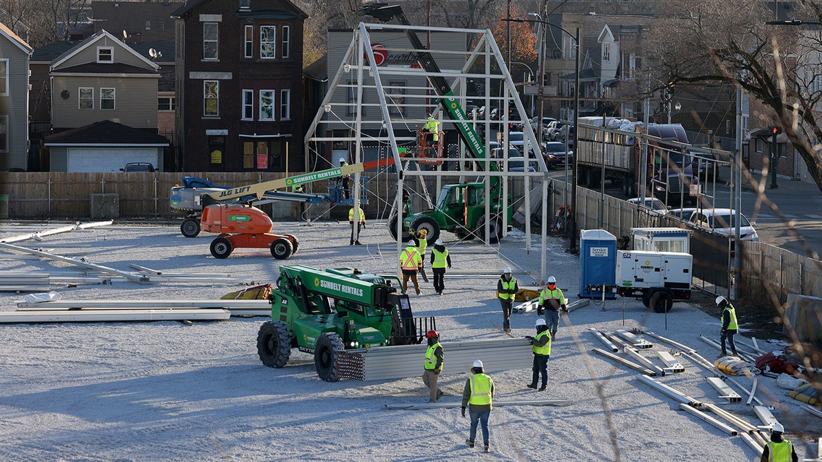Workers construct a migrant tent in Brighton Park in Chicago