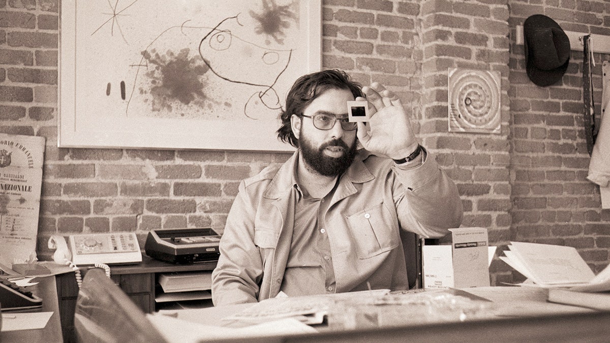 Francis Ford Coppola studying a film still from his office