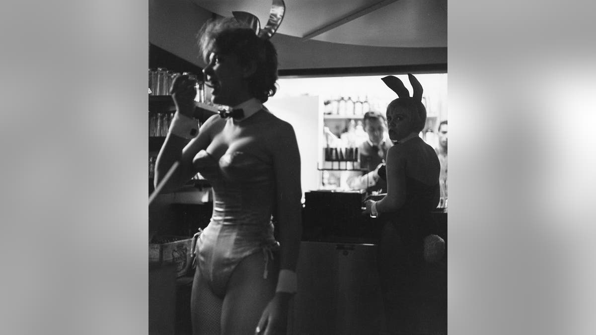 Two Playboy Bunnies working near the bar at the Playboy Club