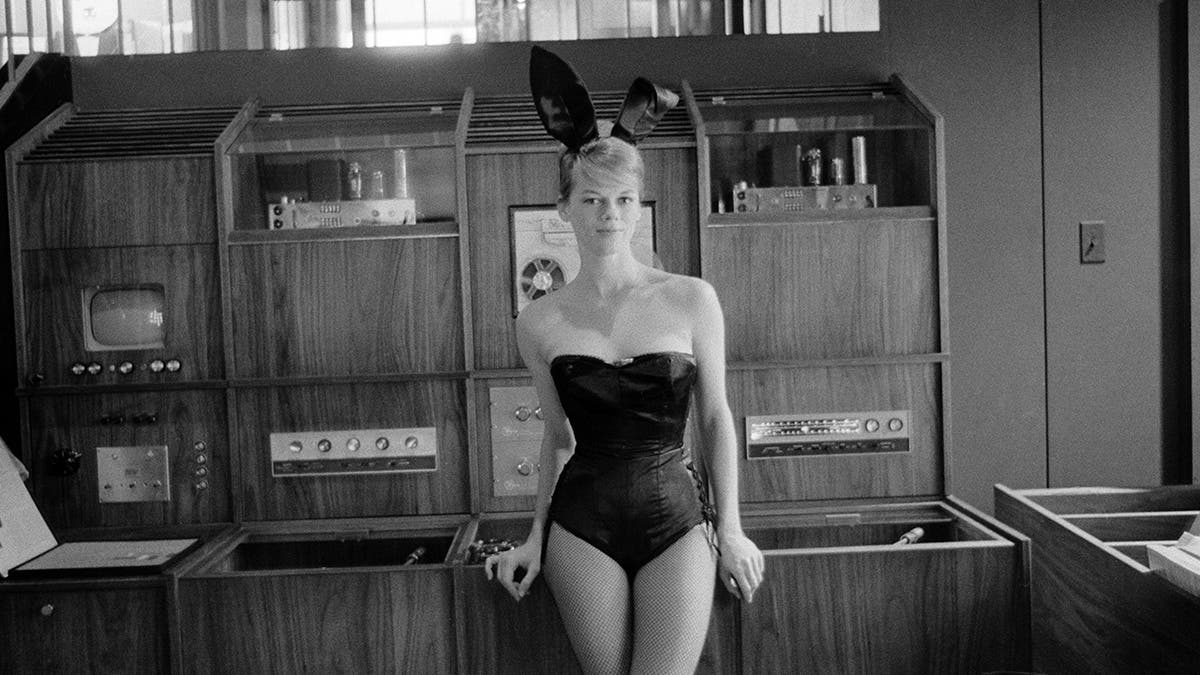 Marli Renfro wearing a black Playboy Bunny suit at the Playboy Club in Chicago