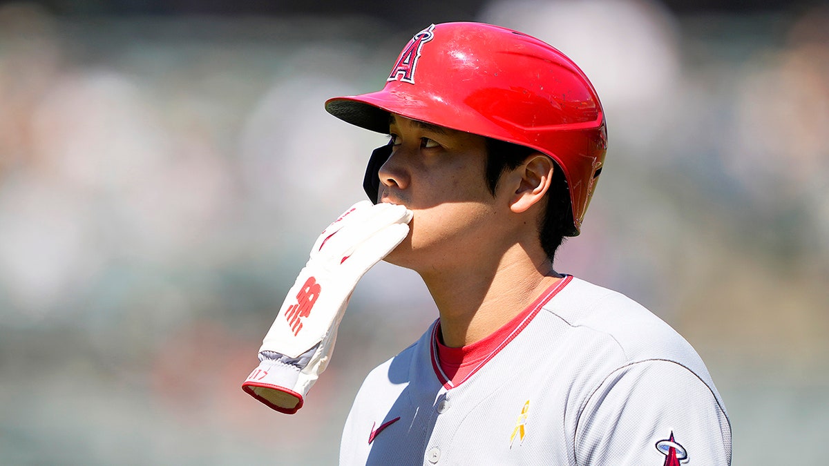 Shohei Ohtani with batting gloves in his mouth