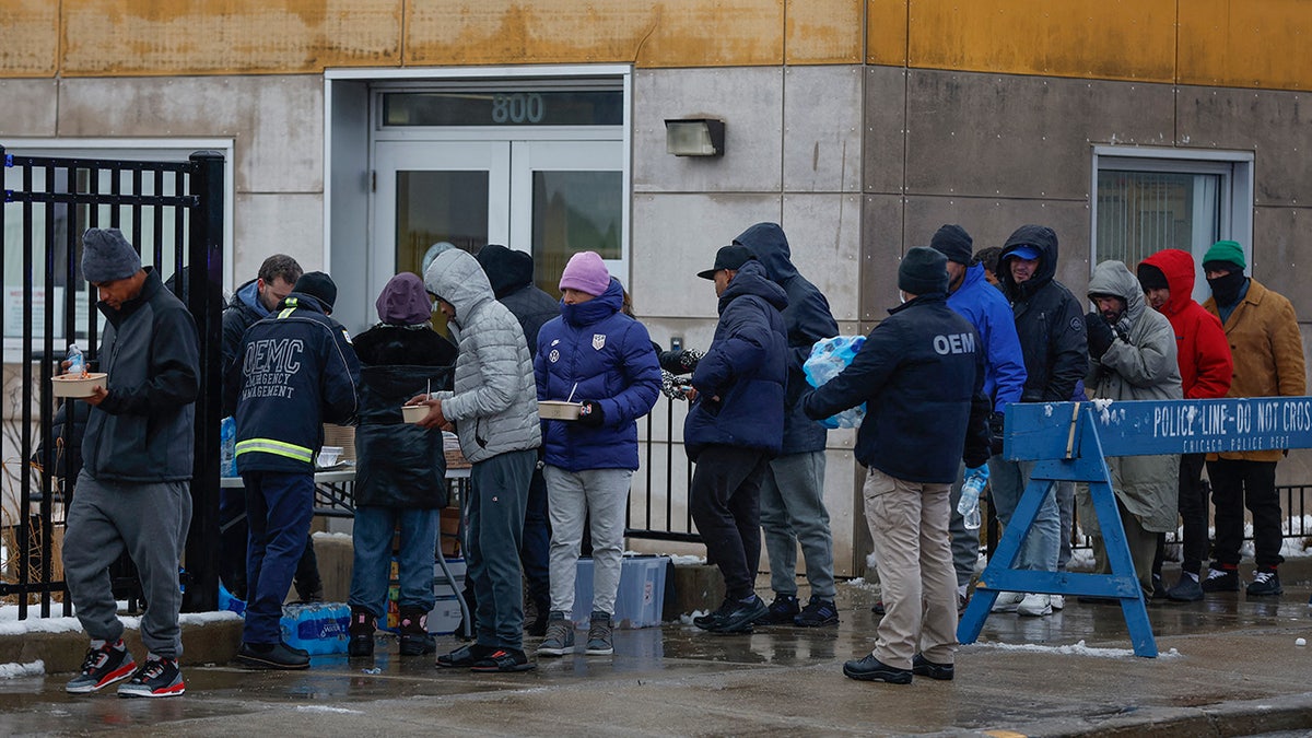 Migrants line up in Chicago cold for food