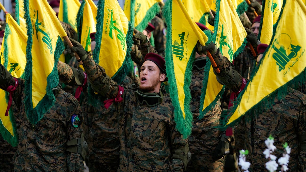 Hezbollah fighters attend the funeral of their commander Wissam al-Tawil
