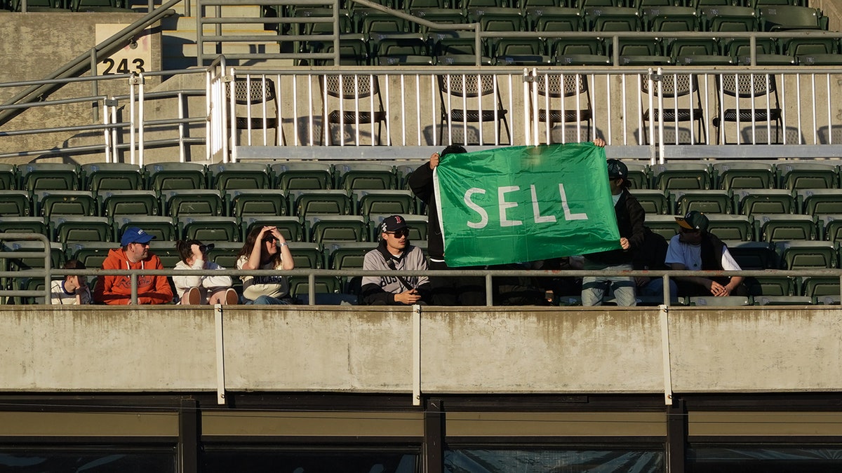 Oakland fan with sell sign