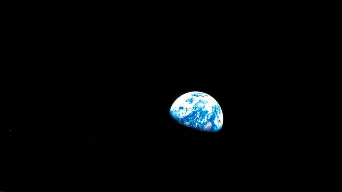 FILE - This Dec. 24, 1968, file photo made available by NASA shows the Earth behind the surface of the moon during the Apollo 8 mission. Retired Maj. Gen. William Anders, the former Apollo 8 astronaut who took the iconic "Earthrise" photo showing the planet as a shadowed blue marble from space in 1968, was killed Friday, June 7, 2024, when the plane he was piloting alone plummeted into the waters off the San Juan Islands in Washington state. He was 90.