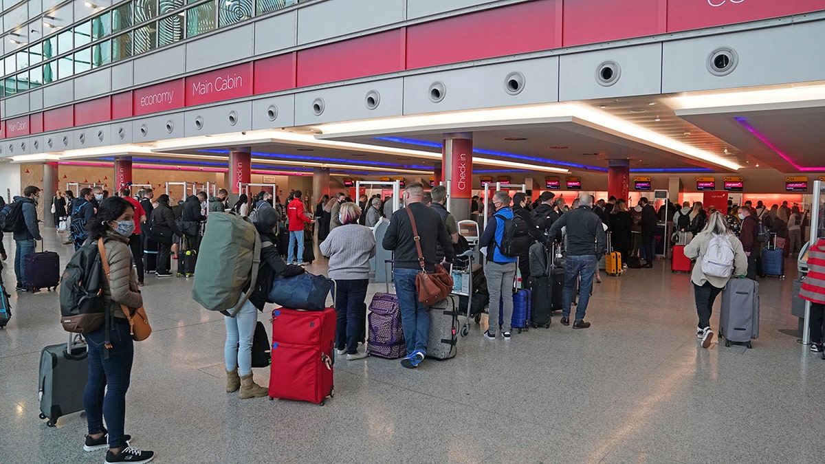 Passengers queue at London Heathrow Airport's T3 as the US reopens its borders to UK visitors in a significant boost to the travel sector in London on Monday.